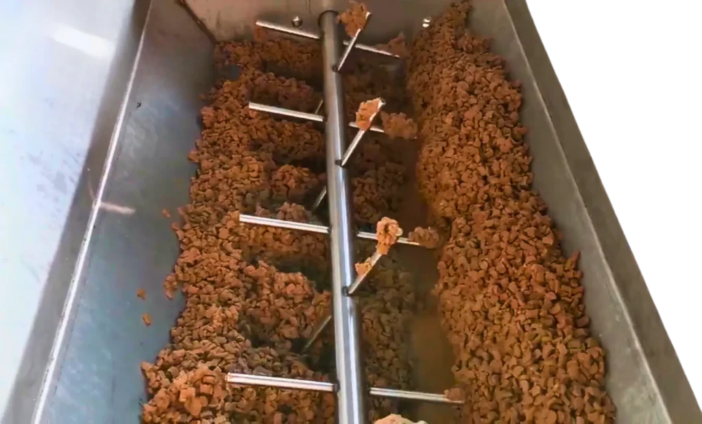 Cold pressed dog food mixing in a machine