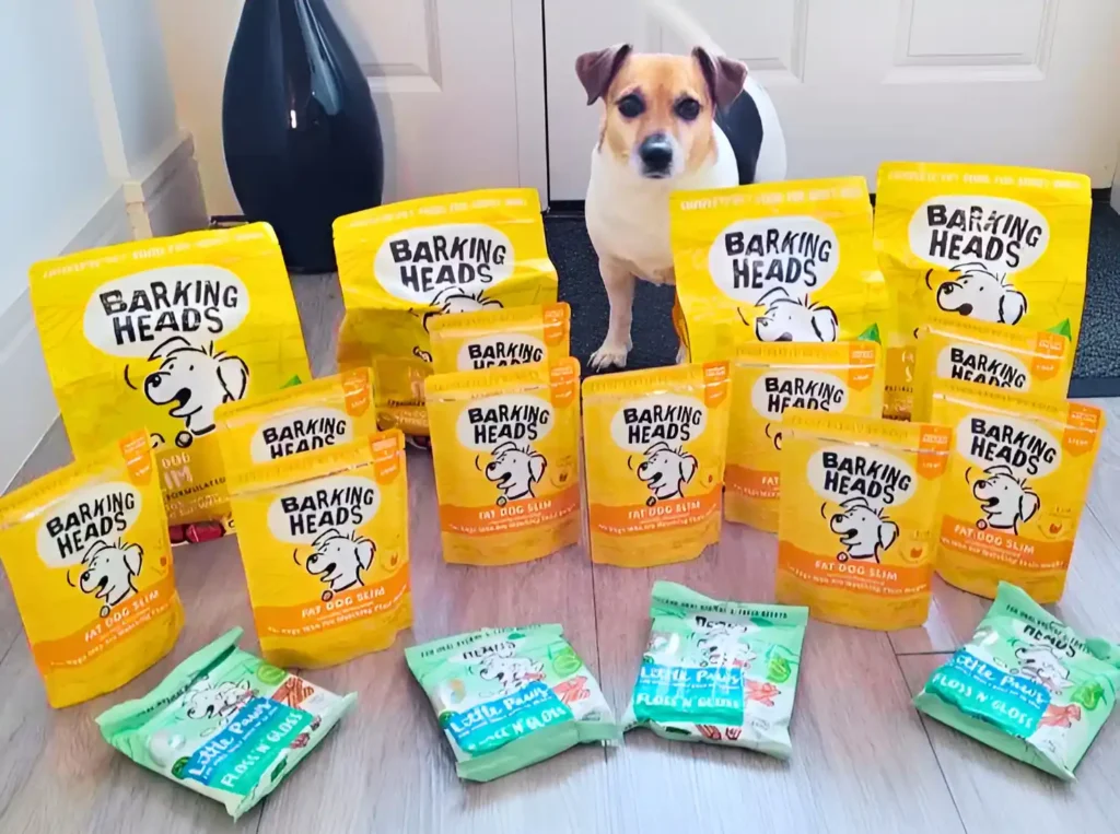 a dog standing next to a bunch of  Barking heads low-fat wet dog food